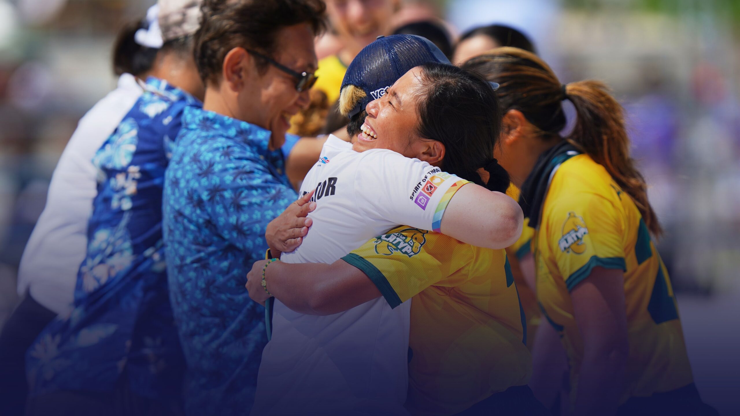 Flying Disc athletes embracing and celebrating together during a competition, highlighting teamwork, friendship, and inclusion in sport.