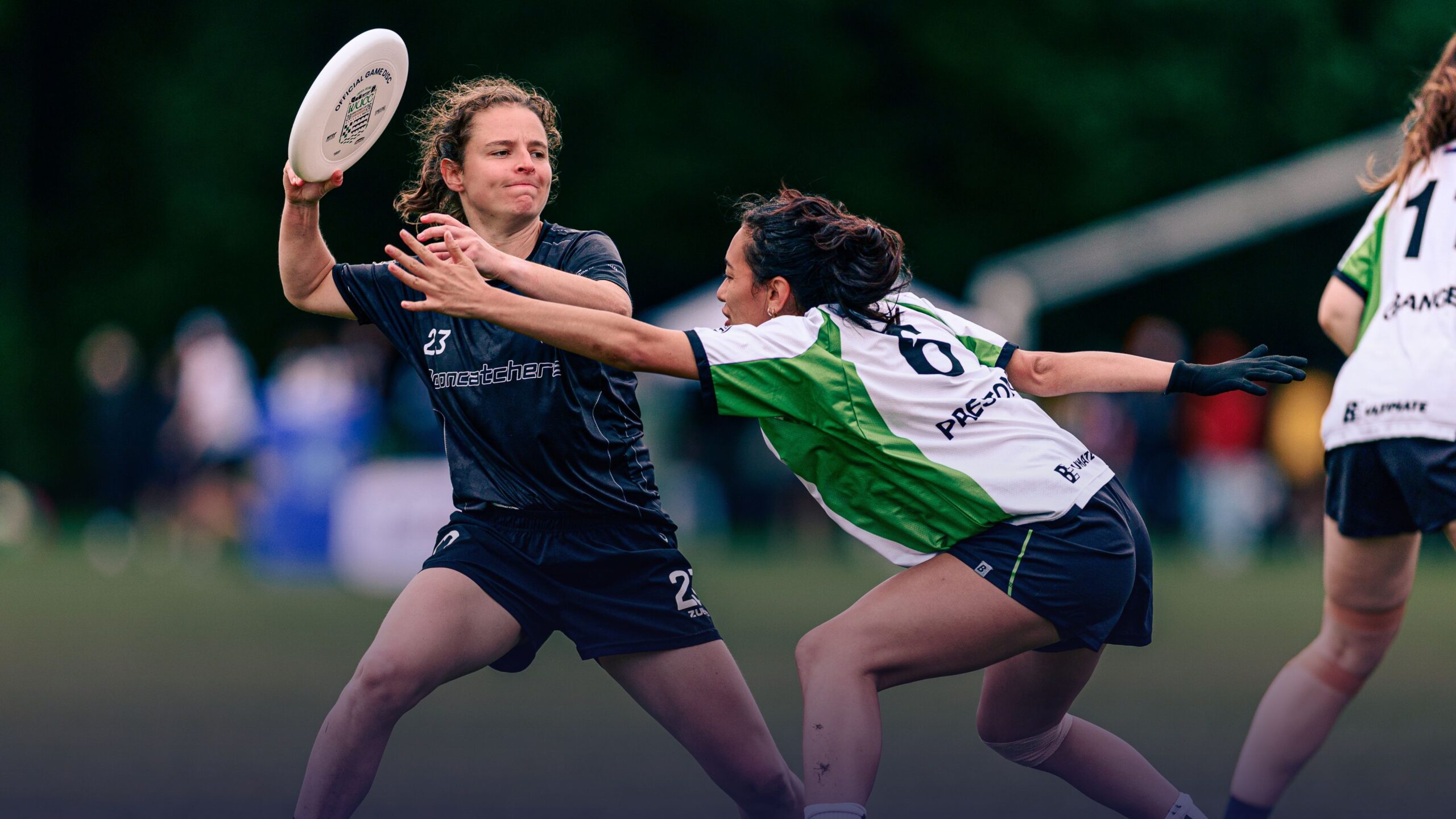Women’s ultimate players compete for the disc during a match.