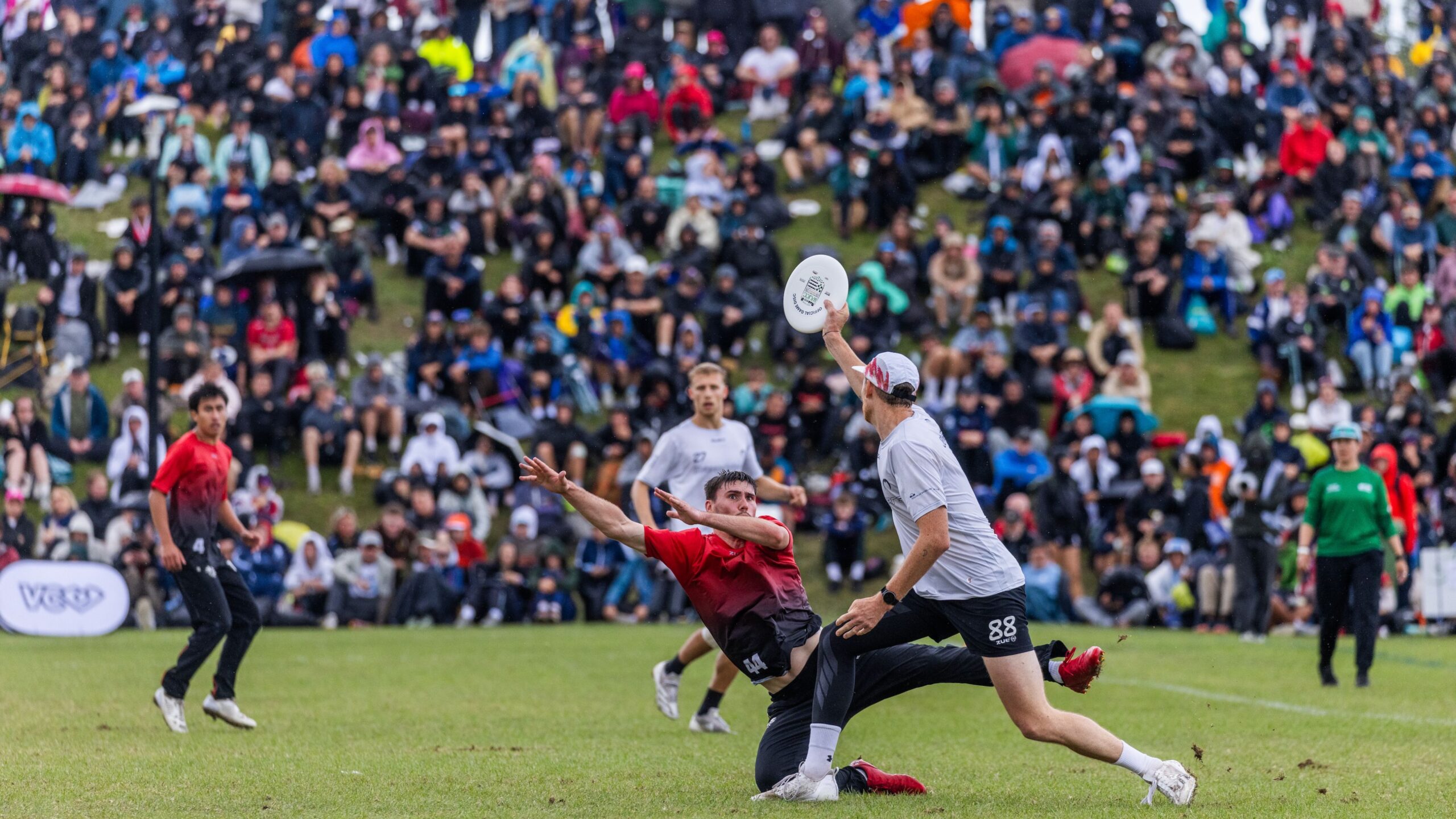 Ultimate players compete for the disc during the WUCC 2026 finals in Limerick, Ireland, in front of a large crowd.