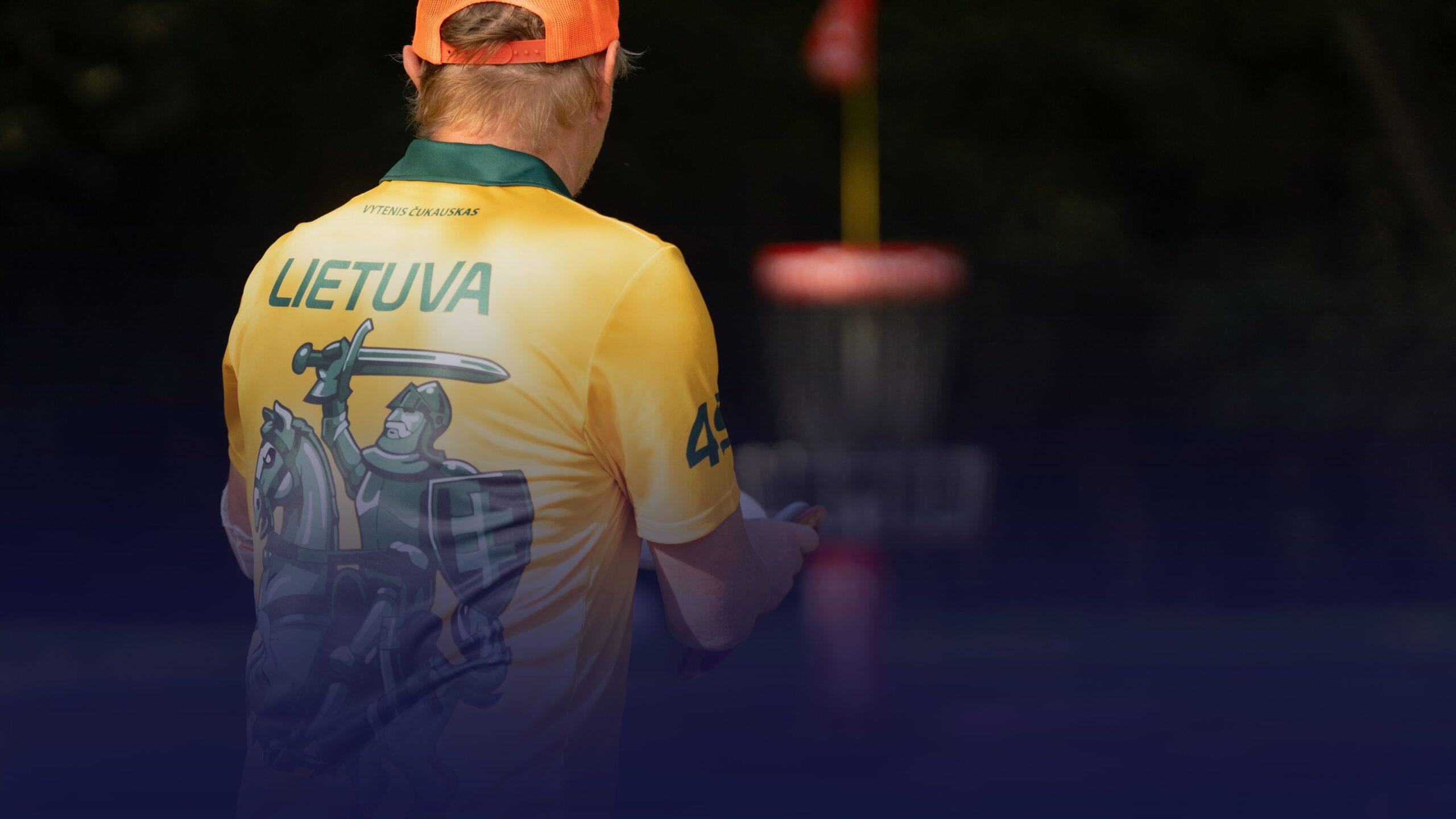 Disc golfer wearing a yellow Lithuania team jersey during the 2026 World Team Disc Golf Championship in Vilnius.
